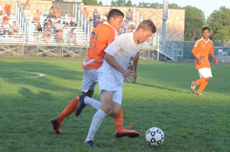 Warsaw's Manuel Rodriguez battles for the ball. Rodriguez scored the tying goal for the Tigers at Concord Wednesday.