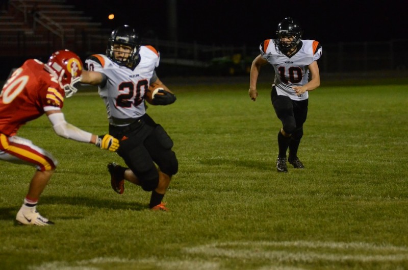 Warsaw's Tristan McClone greets Jared Peen of Elkhart Memorial with a stiff arm Friday night. McClone scored three touchdowns in a 28-0 Tiger win (Photos by Scott Davidson)