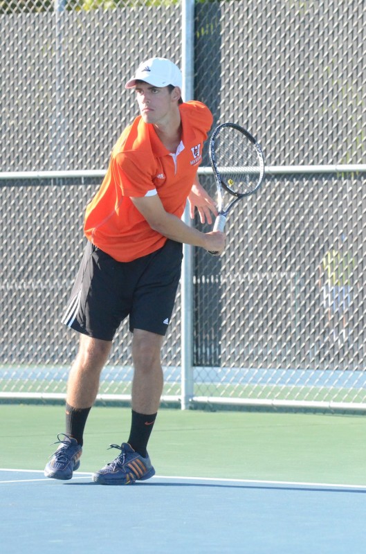Senior Kyle Wettschurack watches his serve in No. 1 doubles play for Warsaw versus Penn Monday at WCHS.