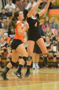 Emily Poe (No. 4) and Marie West almost collide while playing defense for Warsaw Thursday night.