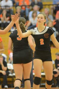 Warsaw senior Laura Craig high-fives a teammate Thursday night.