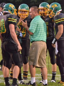 First-year Northridge head coach Tom Wogomon talks strategy with some of his players during a timeout. 
