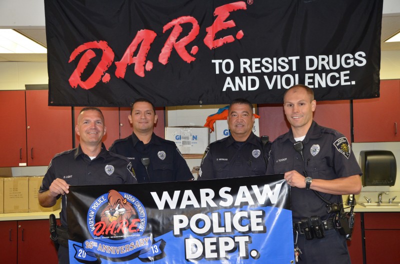 The Warsaw Police Department D.A.R.E. division met today to announce their 25th anniversary teaching students in Warsaw Community Schools.  Photographed (from left) are D.A.R.E. officers Cpl. Doug Light, Cpl. Jaime de la Fuente, Sgt. Dave Morales and Ptl. Jeff Ticknor. (Photo by Alyssa Richardson)