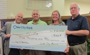 Kevin Deardorff, left, vice president of Lake City Bank, presented a check to Andy Swihart, KC-Ed board; Sariah Morgan, KC-Ed program coordinator and George Brennan, KC-Ed board.