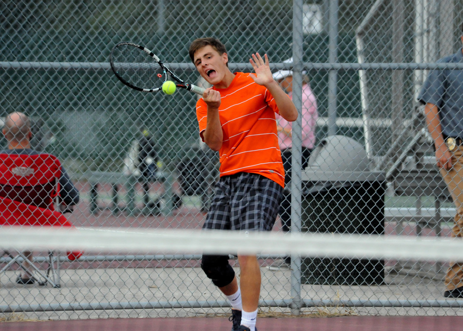 Warsaw's Evan Miller returns volley during his three singles match against Wawasee's Cal Heinisch Tuesday night. Miller won in straight sets. (Photos by Mike Deak)