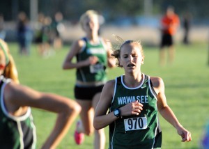 Wawasee freshman Molly Swartz strains to finish the race as teammate Courtney Linnemeier chugs in steps behind.