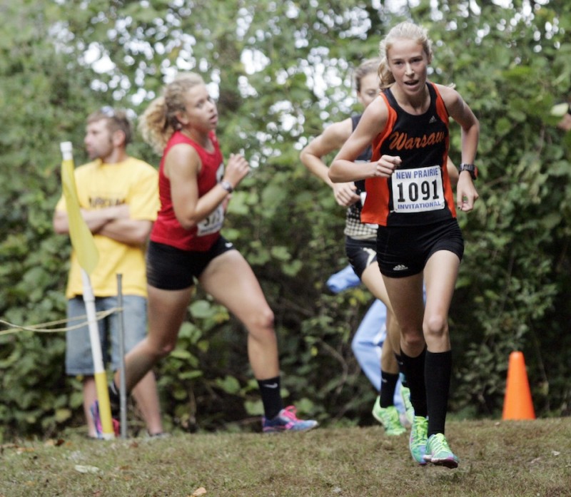 Warsaw freshman Allison Miller turns a corner during action Saturday at the New Prairie Invitational. Miller was 11th overall in the Class AAA race.