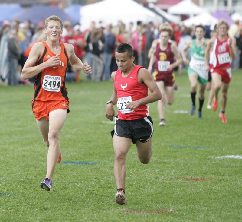 Warsaw's Tyler Houvener (at left) competes Saturday at the New Prairie Invitational.