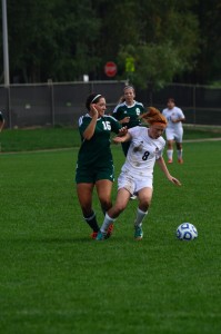 Warsaw's Brooklyn Jackson controls the ball while being defended by Brennah Tadeo of Northridge Saturday. The No. 13 Raiders won 3-0 (Photo by Amanda Farrell)