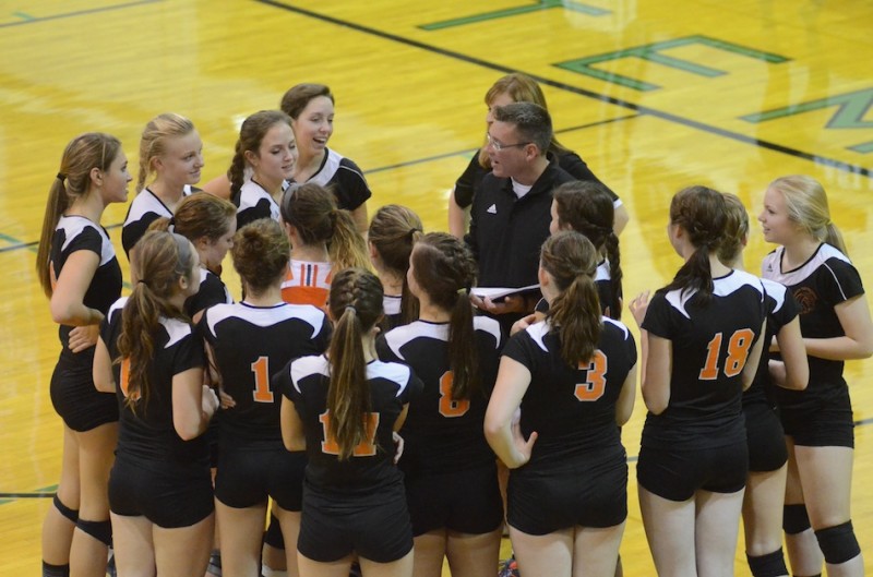 Coach Mike Howard talks to his Warsaw volleyball team prior to the third set Thursday night at Concord.