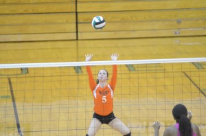 Sophomore libero Peyton Adamiec passes the ball up for Warsaw during a win at Concord Thursday night.