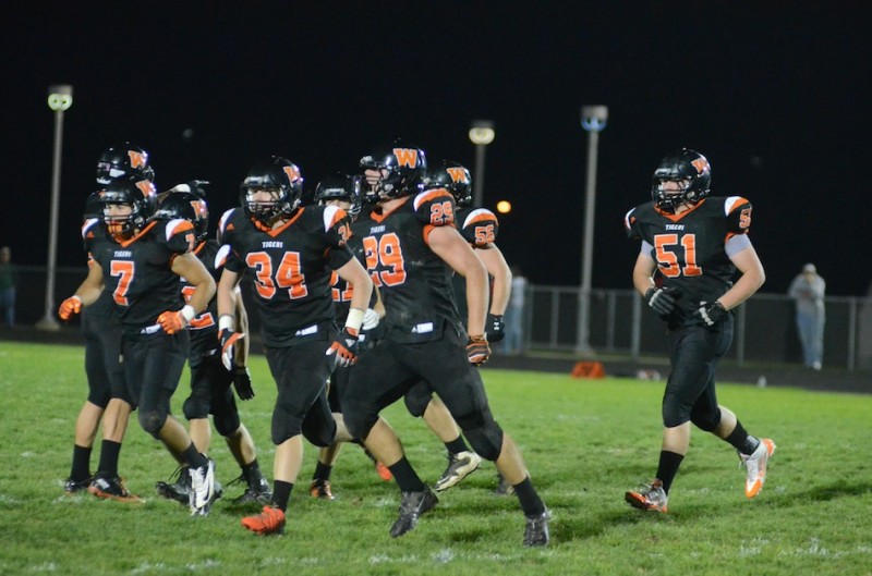 Warsaw's Seth Fouts (No. 29) high steps it off the field after making a first quarter interception Friday night. The Tiger defense came up with four turnovers in a 28-7 home win over NorthWood (Photos by Scott Davidson)