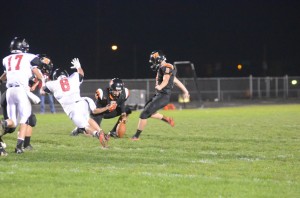 Travis Bear of NorthWood flies in to block a Warsaw field goal try by Caleb Klusman.