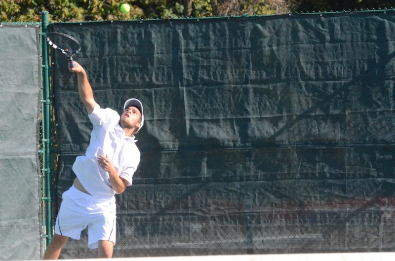 Nikos Schlitt smacks a serve for his No 1 doubles team Saturday.