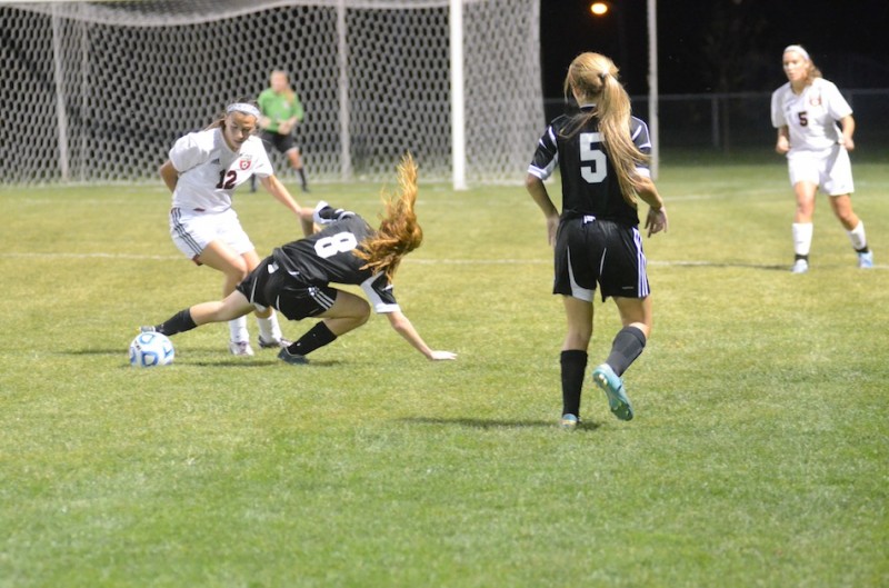 Brooklyn Jackson of Warsaw takes a tumble while battling Taylor Luster of NorthWood for the ball Saturday night in the sectional final.