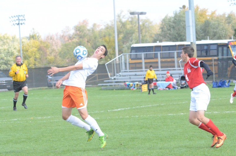 Zach Tucker of Warsaw plays the ball as Michael Tanchevski of Crown Point looks on Saturday. The No. 4 Bulldogs beat the No. 9 Tigers 1-0 in a semifinal match of the Class 2-A Warsaw Semistate (Photos by Scott Davidson)