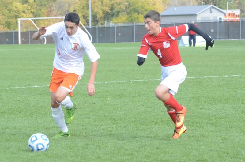 Senior Zach Tucker of Warsaw makes a run as .. of Crown Point gives chase in the semi state at Warsaw Saturday.