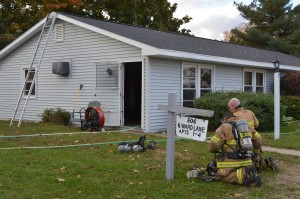 Firefighters put on air packs to enter the apartment at 506 North Ward Lane, Apt. 3, North Webster. (Photo by Deb Patterson)