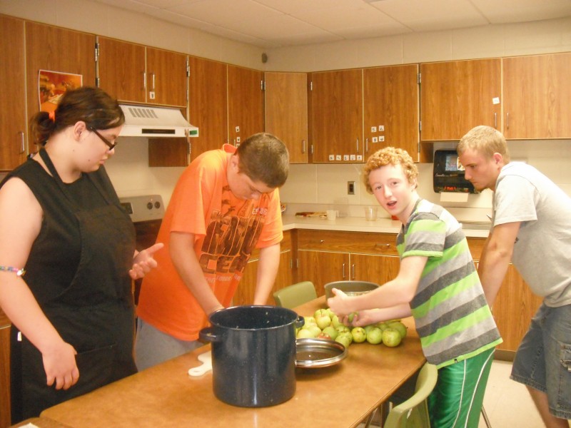 From left, Stacie Castle, Zachary Craig, Derek Dunithan and Michael Turner are making applesauce in a kitchen at Wawasee High School. (Photo provided)