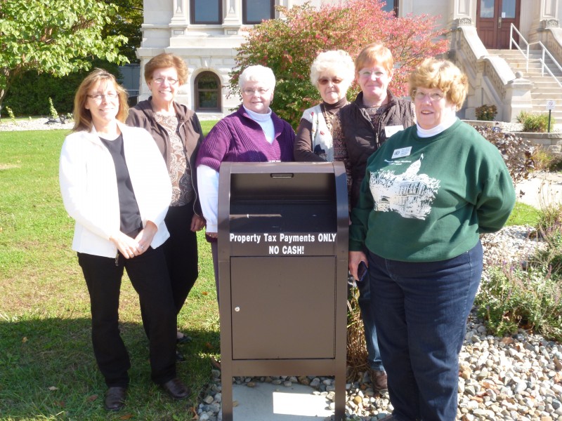 Kosciusko County Treasurer’s Office employees Brenda Smits, Janet Helton, Lila Christner, Delsey Walls; Rhonda Helser, chief deputy; and Sue Ann Mitchell, Kosciusko County Treasurer are anxiously awaiting payments to be dropped in the box located on the west side of the Courthouse on Lake Street.  Payments can be dropped in the box until the tax deadline Nov. 12.  (Photo provided)