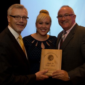 Bri Walgamuth, Akron Concrete Products (center), receives USP Award from Dennis Welzenbach, President (left) and Mark Klingenberger, VP Sales and Marketing of Wilbert Funeral Services. (Photo provided)