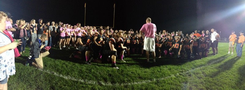 Warsaw football head coach Phil Jensen, pink shirt, tearfully addresses his football team and faithful Friday night after the Tigers beat the Wawasee Warriors 14-13 to reclaim the 'W' Trophy. (Photos by Mike Deak) 