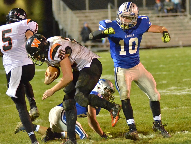 Carroll's Alex Bartkus body checks Warsaw's Tristan McClone out of bounds in the fourth quarter of Carroll's 42-7 win. (Photos by Nick Goralczyk)