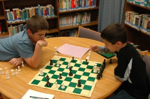 Cameron Heinisch, left, an Evan Brower are finishing up a spirited game of chess at a recent Milford Chess Club meeting.