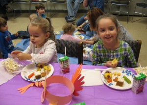Grace and Lily Douglas enjoy their favorite finger foods at the Library’s annual Preschool Thanksgiving Feast held last week.  The children brought in finger foods and enjoyed story time and feasting.
