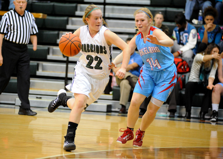 Hannah Haines of Wawasee speeds past Lakeland guard Cori Vaughn during play Tuesday night. Lakeland would rally from 12 down to beat Wawasee, 37-33, in overtime. (Photos by Mike Deak)