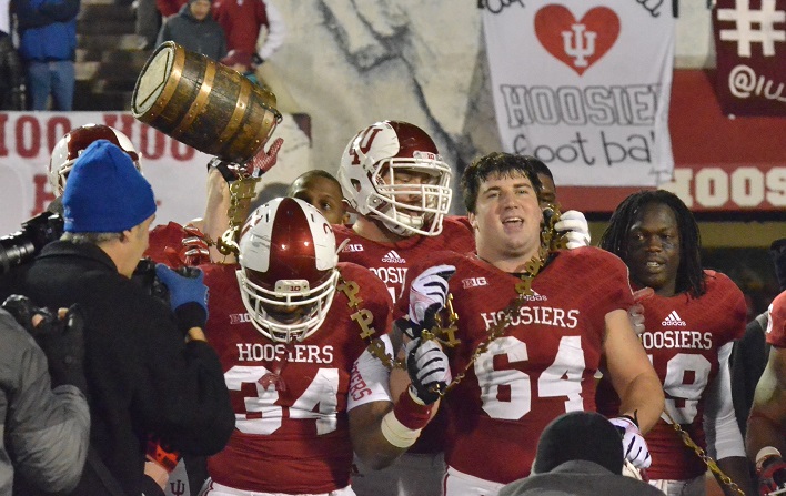 Seniors Jacarri Alexander (34) and Colin Rahrig (64) lead the team and the Old Oaken Bucket over to the Hoosier's sideline following Indiana's 56-36 victory over Purdue. (Photos by Nick Goralczyk)