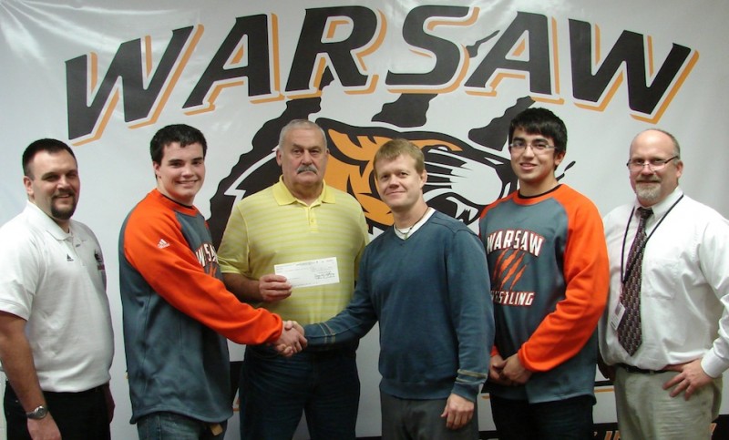 The Warsaw wrestling program led a fundraising campaign for injured Homestead wrestler Nik Gogos. Shown above (from left) are Warsaw wrestling coach Justin Smith, wrestler Anthony Hendrickson, Jerry Nolin of Dairy Queen, Wayne Hogenson of We Care Chiropractic, wrestler Rory Nolin and WCHS Athletic Director Dave Anson (Photo provided)