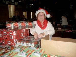 Coordinator, Jane Nolin wrapping presents for Elks Annual Christmas Party