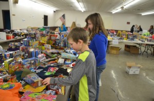 (left) Lucas Vargo, 9, and Ellen Kreider, 10, carefully assess toys to ensure the perfect donation for a family in need.  