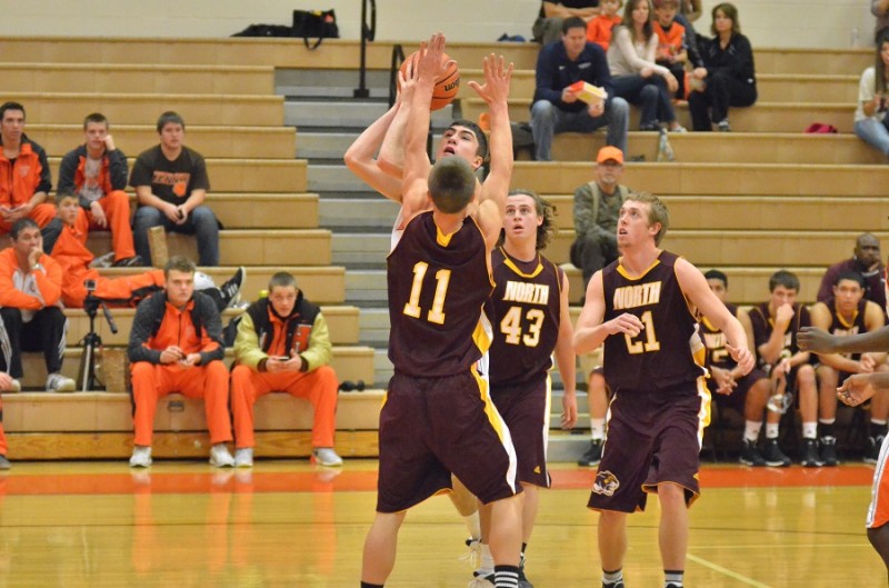 Jake Mangas goes up in traffic for Warsaw and makes contact with Grant Sims of Bloomington North.