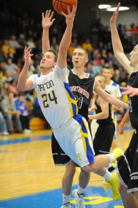 Tanner Shepherd of Triton flies between NorthWood's Jon Wilkinson (21) and Will Stueve.