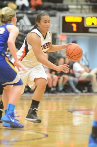 Warsaw senior Brooklyn Harrison drives past a Triton defender Saturday night. Harrison had a big game as the Tigers won 41-31 at Grace College.