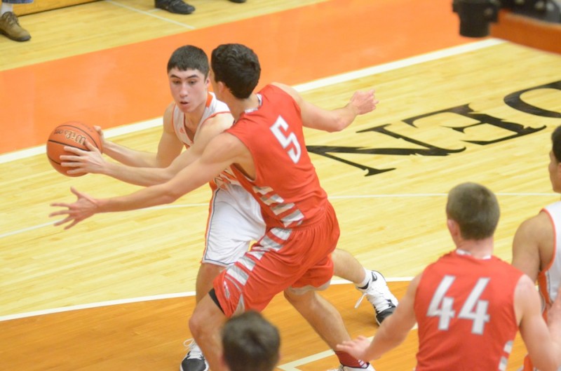 Jake Mangas of the Tigers looks for a teammate while being guarded by Alex Haney.