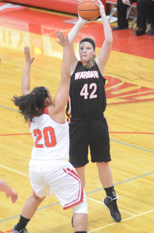 Nikki Grose eyes a jumper for Warsaw Saturday night at Goshen. Grose scored a game-high 20 points in a 44-34 NLC win for the Tigers.