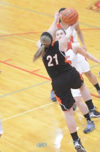 Jodie Carlson scoops up a reverse layup for the Tigers.