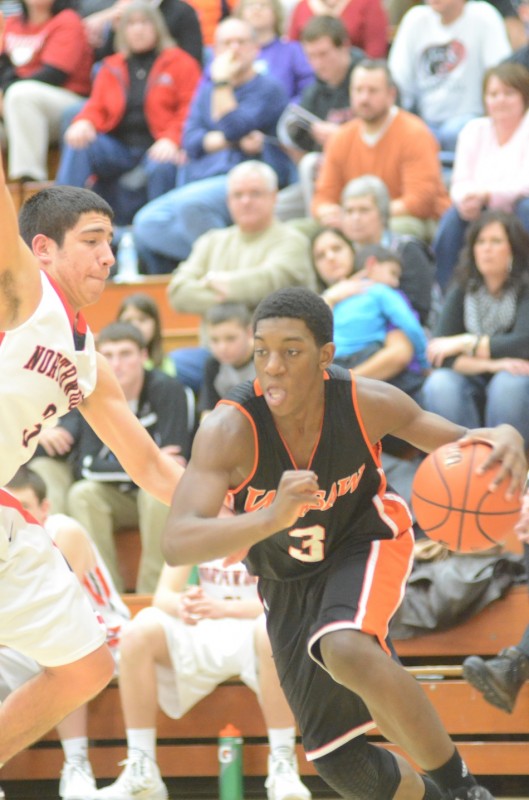 Sophomore Paul Marandet of the Tigers drives past NorthWood's Braxton Linville.
