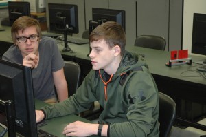 Wawasee High School students Joseph Lyles, left, and Zach McKee are using a computer in Allen Coblentz’s civil engineering and architecture class to design a library. The class is one of several at Wawasee where students can earn both high school and college credits.