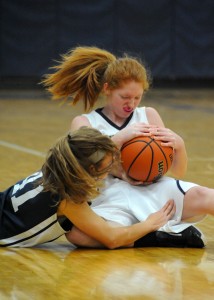 Emily McCoomb of LCA and Catherine Riati of South Bend Trinity fight for a loose ball.