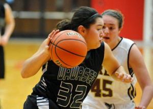 Allissa Flores of Wawasee dribbles past Brebeuf's Gracie Medcalfe.