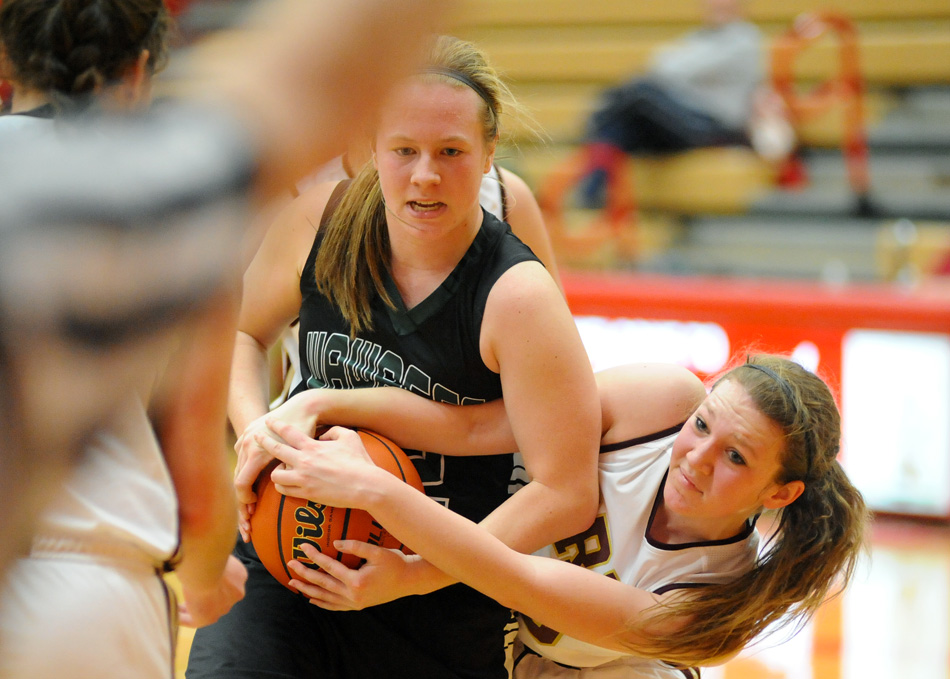 Hannah Haines of Wawasee and Gracie Medcalfe of Brebeuf fight for a loose ball.