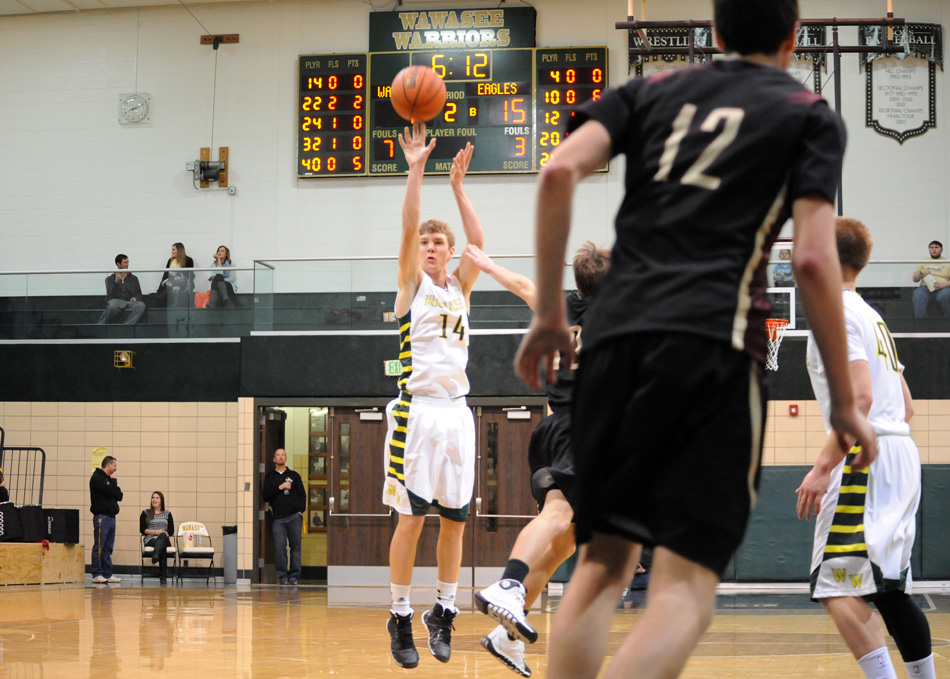 Gage Reinhard of Wawasee hoists a three-point shot attempt against Columbia City.