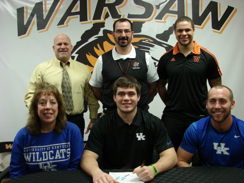 WCHS senior Seth Fouts will attend Kentucky to compete for their track and field team. The standout shot putter is flaked by his mother Cheryl and brother Chad. In back are WCHS Athletic Director Dave Andson, WCHS boys track head coach Matt Thacker and WCHS throws coach Leonard Wells (Photo provided)