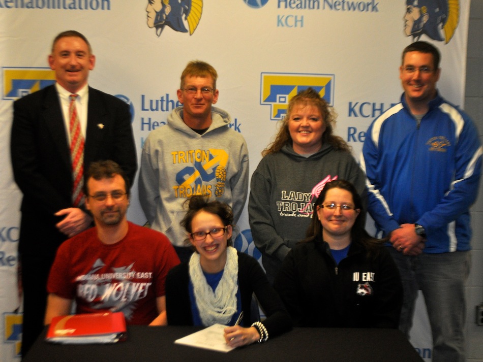 Triton senior Allie Kann signs to attend IU East to compete in cross country and track. Kann is surrounded by her parents Jason and Nicole. In back are Brett Crowley (IU East coach), Todd Hoffer (Triton assistant coach), Shelly Feldman (Triton girls track coach) and Wes Rettinger (Triton girls cross country coach).  (Photo provided)