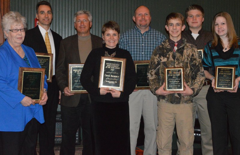 In front are Linda Hathaway, Lyn Crighton who accepted the award for Chuck Brinkman, Kevin Schlipf, and Kylie Flemming with Tom Ray, Don Buhrt, Shawn Krull and Jake Templin in back. These individuals received various awards at the Annual Meeting of Kosciusko County SWCD tonight. (Photo by Deb Patterson)