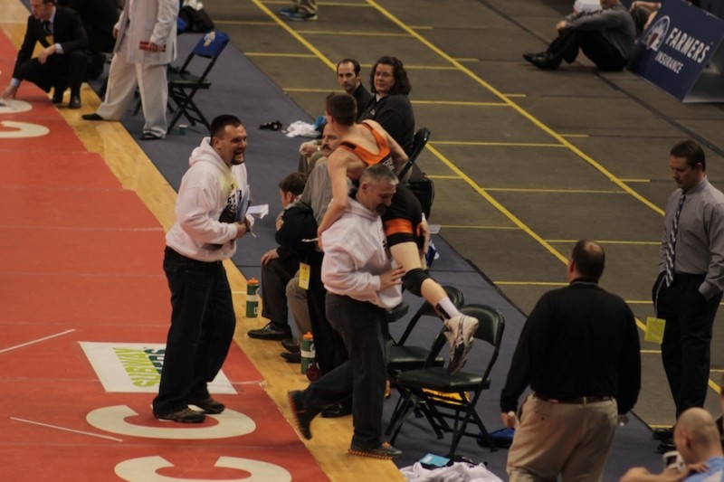 Warsaw freshman Kyle Hatch is carried in celebration by his father/coach Dan Hatch following his 13-12 win at the State Finals Friday night in Indianapolis (Photos provided by Scott Gareiss)